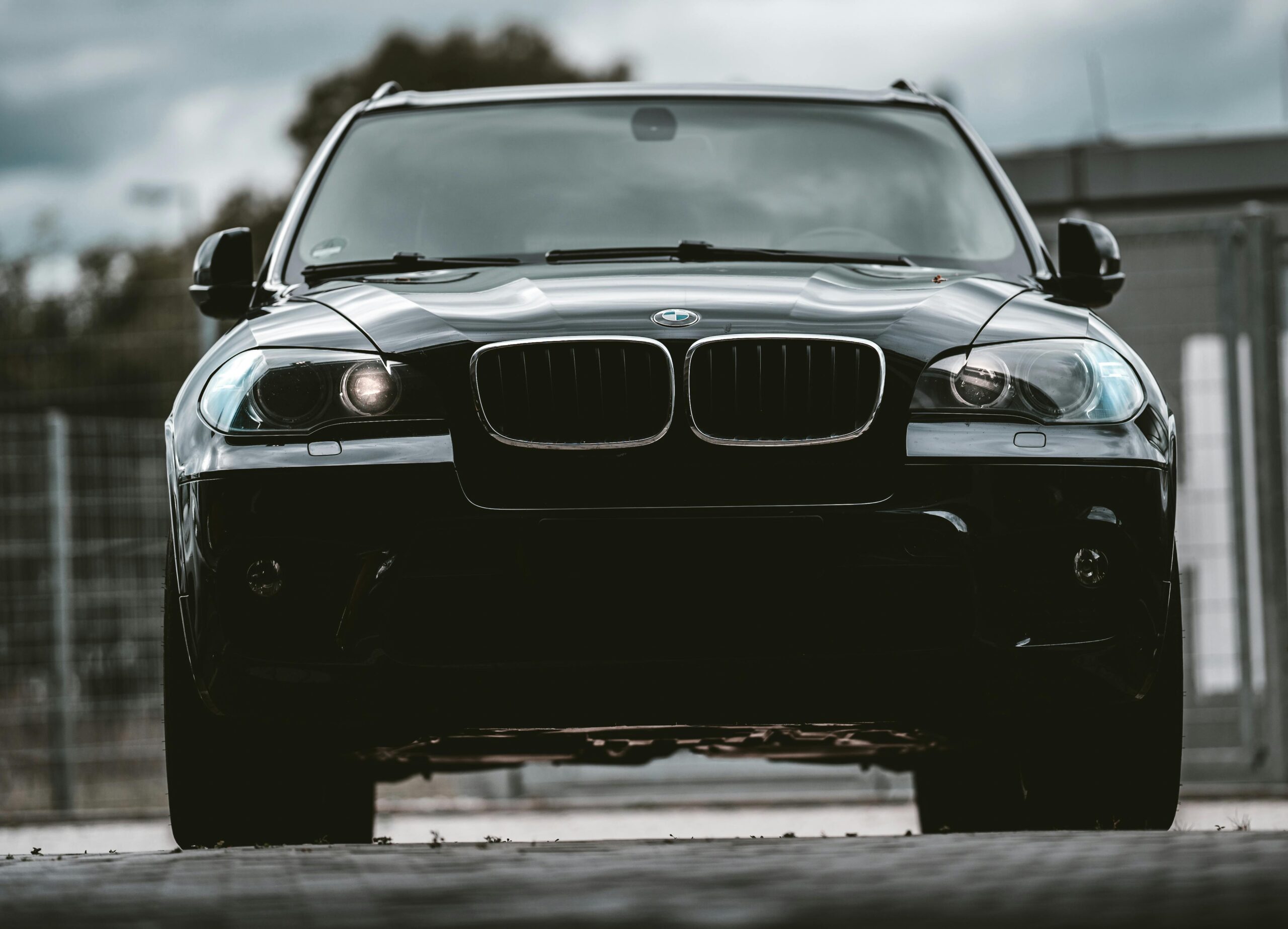 Elegant black BMW car captured from the front, showcasing its luxury and style.